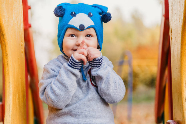 little cute kid playing on the playground, autumn - Фото, зображення