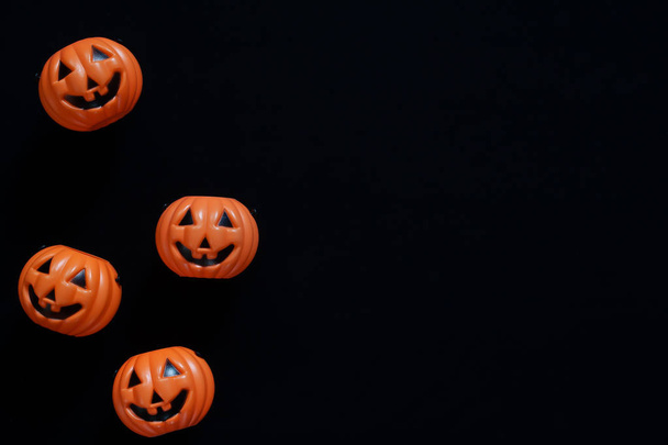 Creative flat lay of Halloween pumpkins on black background  - Photo, Image