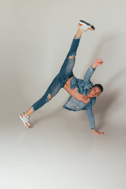 shot of jump feet up, of mad, crazy, cheerful, successful, lucky guy in casual outfit, jeans, jumping with hands up, triumphant, gesturing against white background, sport - Fotoğraf, Görsel