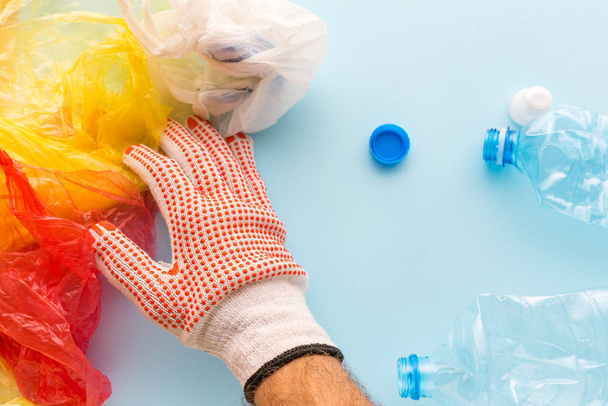 Worker sorting plastic garbage for recycling, conceptual image - Photo, image