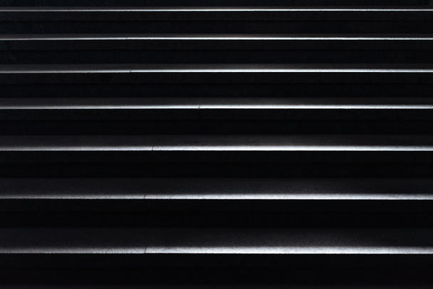 shiny horizontal metal strips on black, full frame view - Photo, Image