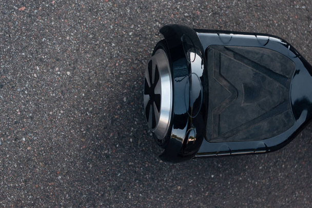 top view of black self-balancing scooter on street   - Фото, изображение