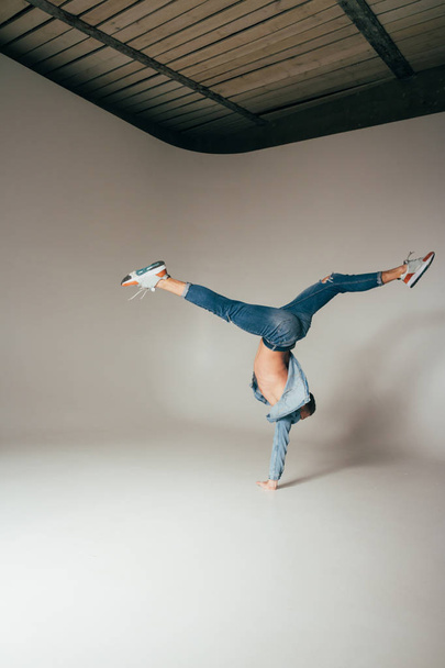 shot of jump feet up, of mad, crazy, cheerful, successful, lucky guy in casual outfit, jeans, jumping with hands up, triumphant, gesturing against white background - Foto, Bild
