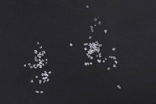 Natural sea iodized salt  isolated on a black background, top view - Valokuva, kuva