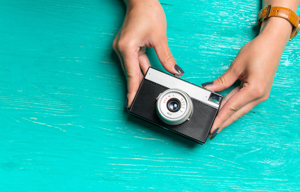 woman's hands holding a retro camera - Photo, image