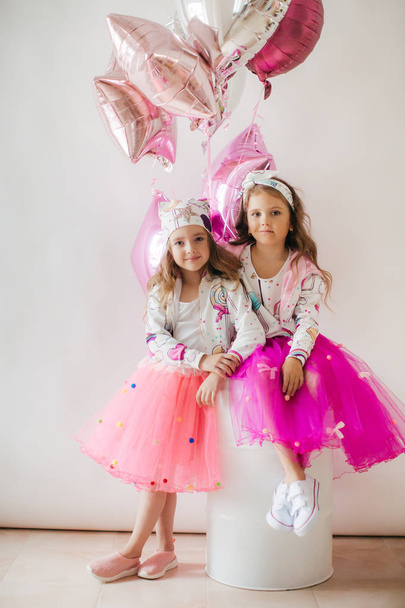 Cute little girls in posing in fashion clothes, happy childhood concept  - Fotó, kép