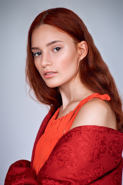 portrait of elegant fashionable girl with red hair, isolated on grey - Фото, зображення