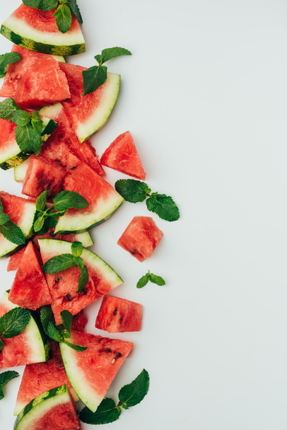 top view of fresh red watermelon slices and mint leaves, on grey background - Photo, Image