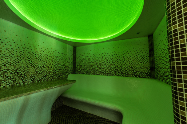 Interior of a Tutkish steam bath (hamam) with tile and green light - Foto, Imagem
