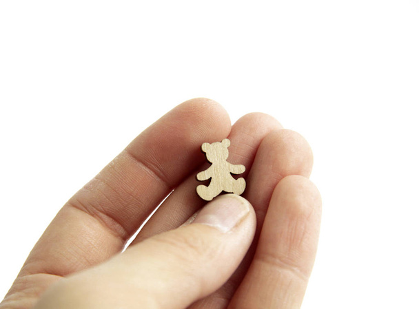  laser cutting wood bear in hand on white background - Photo, image