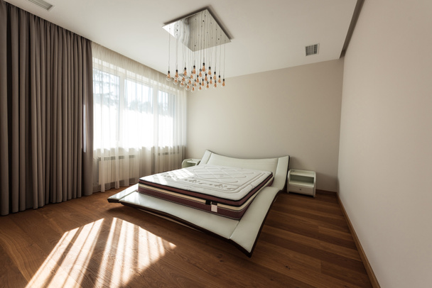 interior of modern bedroom with bed and light bulbs on ceiling - Foto, immagini