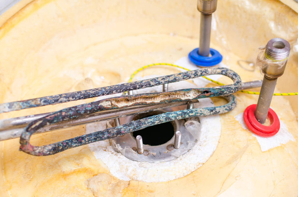 Boiler repair, replacement of broken water heating element. - Фото, зображення