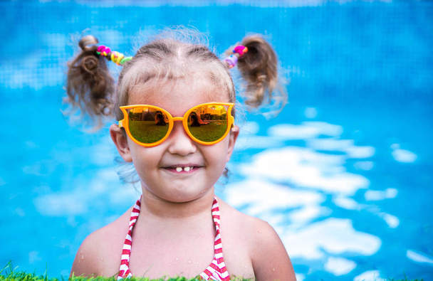 Little beautiful girl having fun  in the pool  - Photo, Image