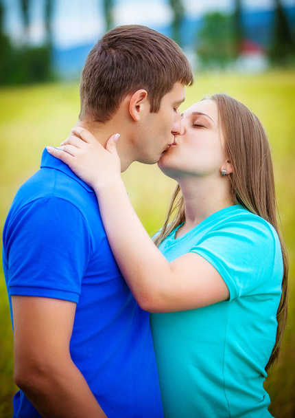 Romantic couple kissing posing in park - Fotó, kép