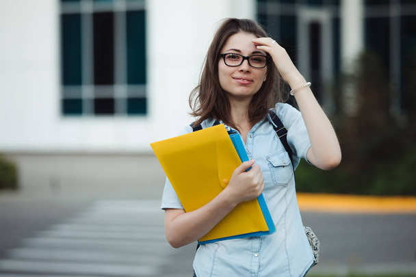 Student girl portrait outdoors near college or university holding folders ready to study - Φωτογραφία, εικόνα