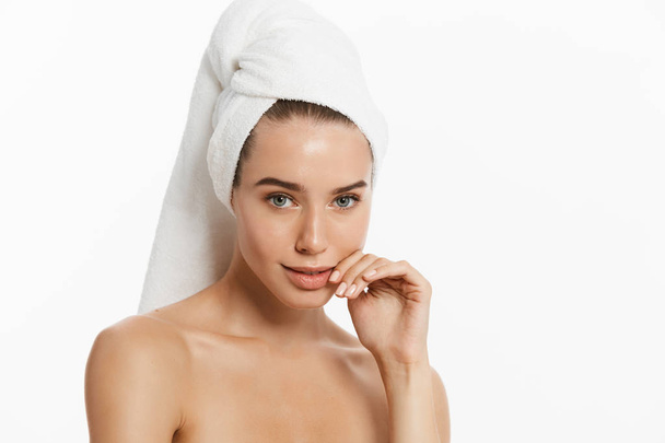Spa skin care beauty woman wearing hair towel after beauty treatment. Beautiful young woman with perfect skin isolated on white background. - Photo, Image