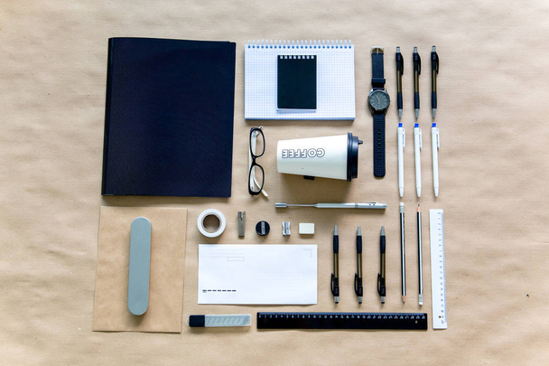 stationery pen scissors notebook on a wooden table - Fotó, kép