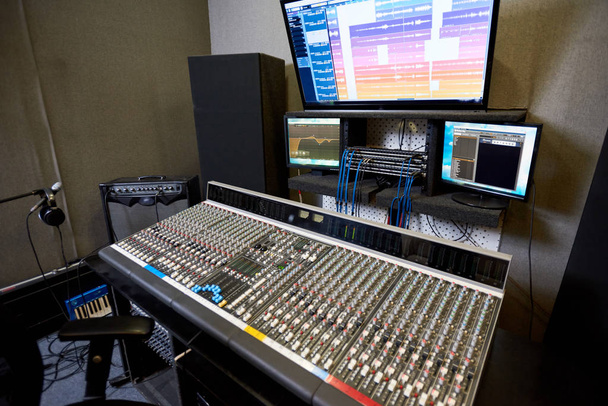 Interior shot of modern control console and monitors in contemporary music recording studio.  - Photo, Image