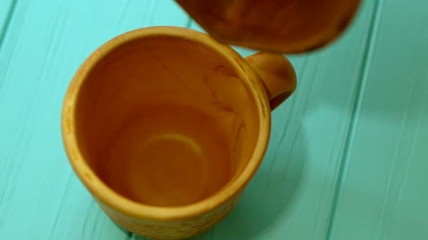Person pouring fresh milk into a mug - Кадри, відео