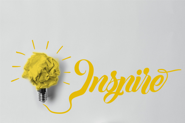 top view of crumpled paper as light bulb with inspire lettering - Photo, Image