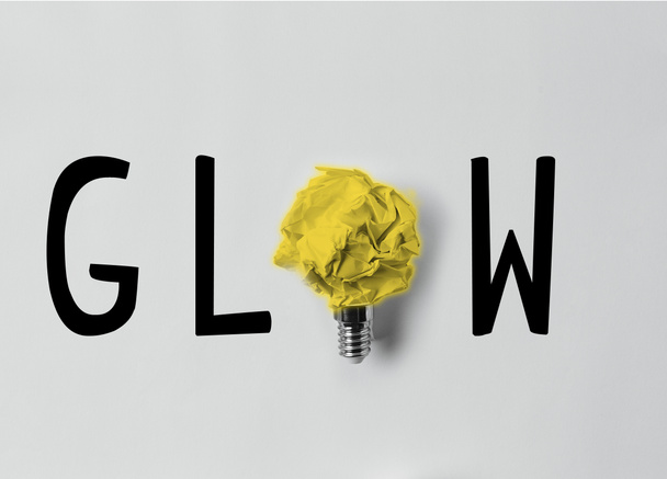top view of crumpled paper as light bulb with glow word - Photo, Image