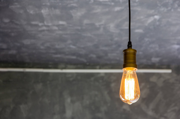 lighting lamp hang hanging from the ceiling gray cement background - Photo, Image