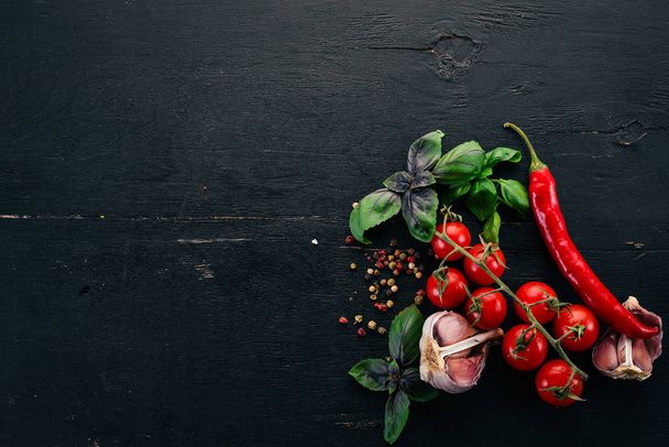 Food Background. Cherry tomatoes, spices and sauces. Top view. On a wooden background. Free space for text. - Фото, изображение