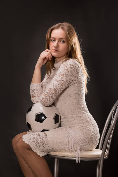 Beautiful, young girl with a soccer ball. - Фото, изображение
