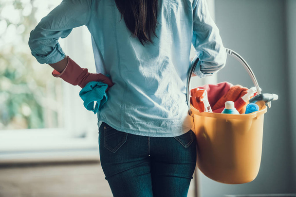 Young Woman holds Bucket with Cleaning Equipment - Foto, Imagem