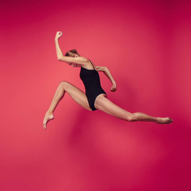 Young teen dancer on red studio background. - Foto, Imagen