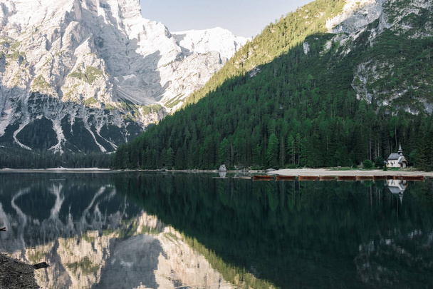 majestic view of reflections on beautiful lake in mountains, Lago di Braies, Italy - Foto, imagen