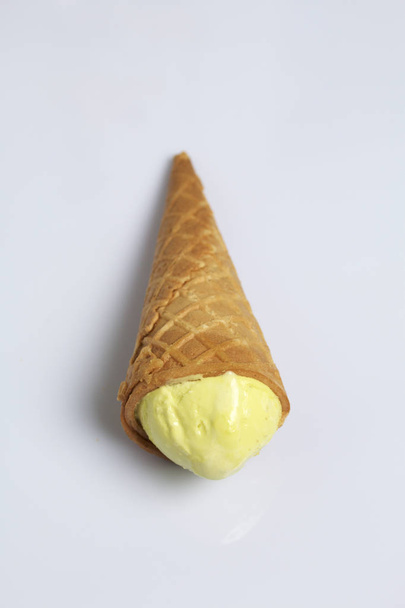 Ice cream in a waffle horn. Lies on a white background. - Фото, изображение