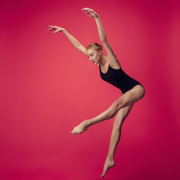 Young teen dancer on red studio background. - Zdjęcie, obraz
