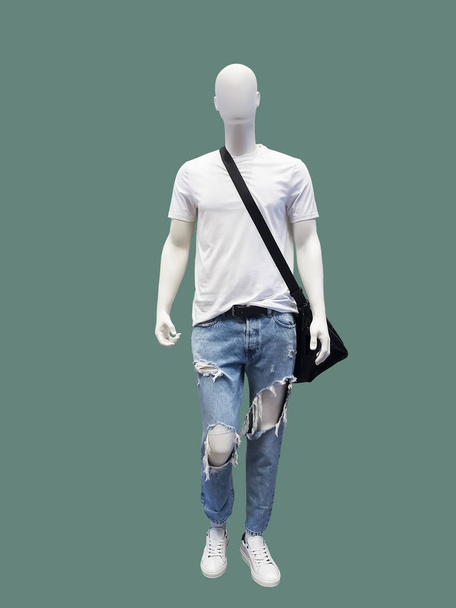 Full length male mannequin dressed in t- shirt and blue ripped jeans, isolated. No brand names or copyright objects. - Photo, Image