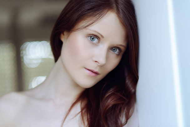 tender portrait of beautiful young woman with blue eyes and red hair - Foto, imagen