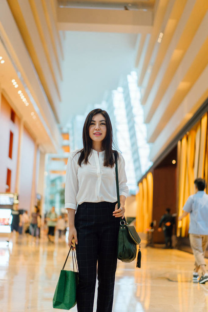 Young attractive asian woman with shopping bag in the mall  - Φωτογραφία, εικόνα