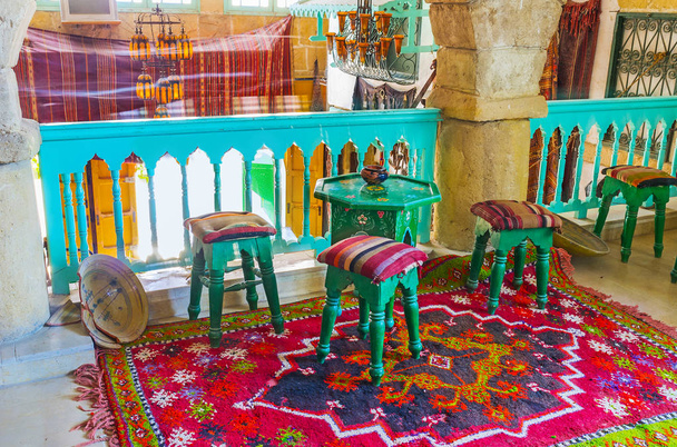 SOUSSE, TUNISIA - SEPTEMBER 1, 2015: Interior of authentic Tunisian restaurant and teahouse with glass vintage chandeliers, carved wooden furniture and handmade carpets, on September 1 in Sousse. - Фото, зображення