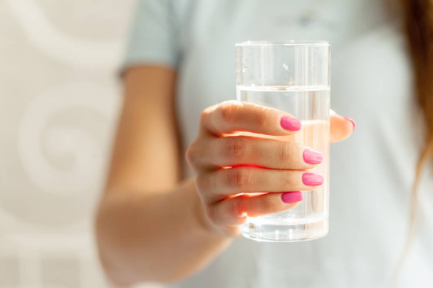 Woman holding a glass of water, close-up - Photo, Image