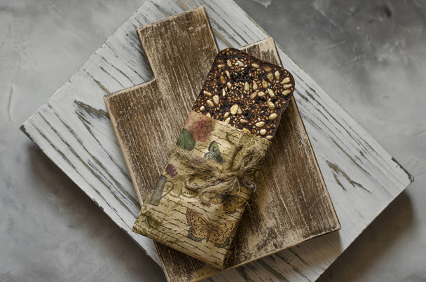 Chocolate with sesame seeds of pine nuts and goji berries   - Photo, Image