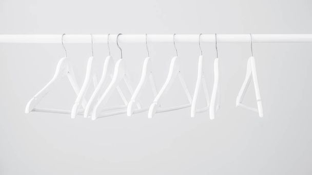 Empty wooden hangers for clothes - Φωτογραφία, εικόνα