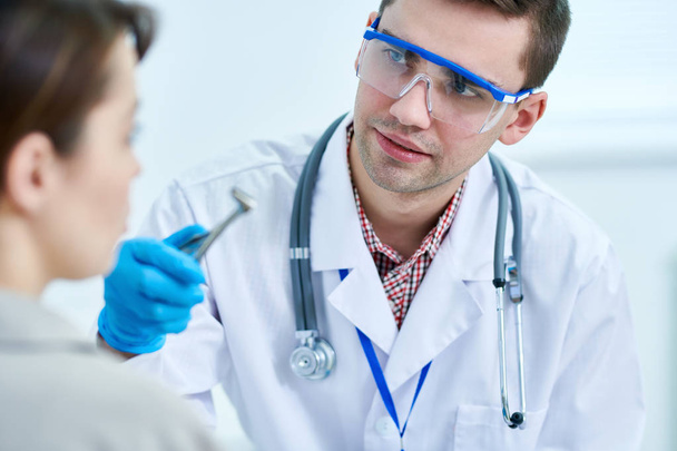 Portrait of young physician preparing to examine patient in clinic, copy space - Photo, Image