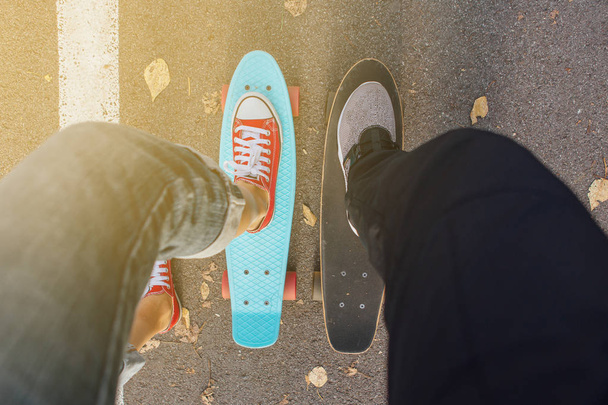 Close up of feet of a girl in red sneakers rides on blue penny skate board with pink wheels. Urban scene, city life. Sport, fitness lifestyle. - Fotoğraf, Görsel