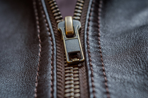 Close up of the zip of an elegant brown leather jacket - Photo, Image
