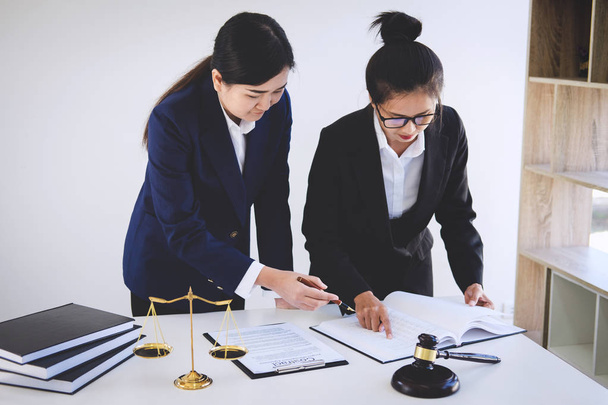 Teamwork of business lawyer colleagues, consultation and conference of professional female lawyers working having at law firm in office. Concepts of law, Judge gavel with scales of justice. - Photo, Image