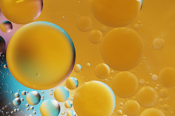 Abstract oil balls of water drops of yellow and blue color - Foto, immagini