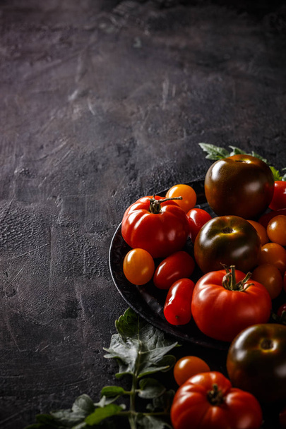 Fresh, ripe tomatoes on black background - Photo, Image