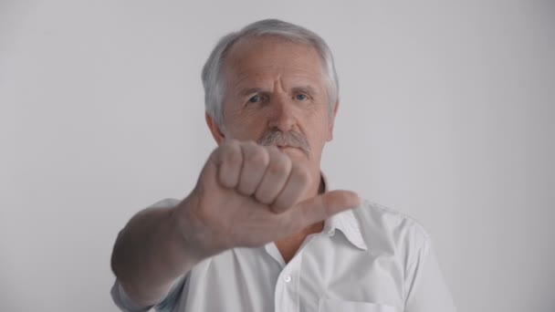 Gray-haired senior man showing his thumb down. Sign of reject - Footage, Video