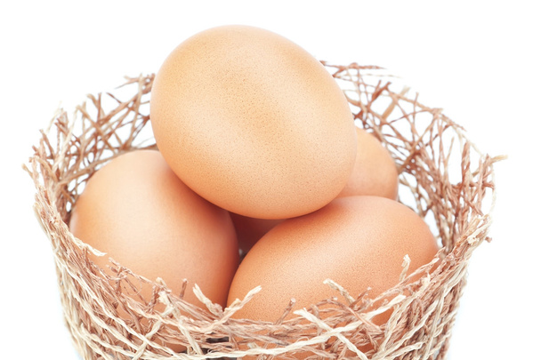 Chicken nest and a group of Easter eggs. On a white background. - 写真・画像