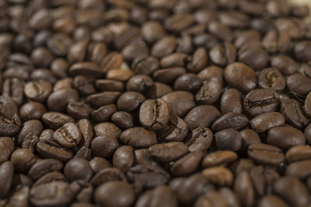Macro de un grano de café en granos de café tostados
. - Foto, imagen
