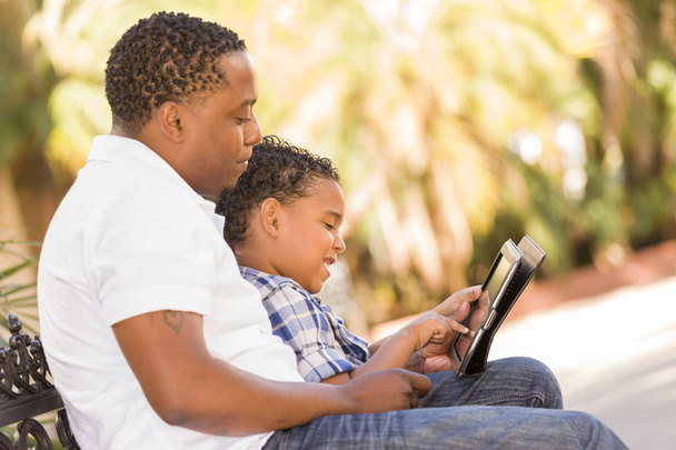 Mixed Race Father and Son Using Touch Pad Computer Tablet - Foto, Imagen